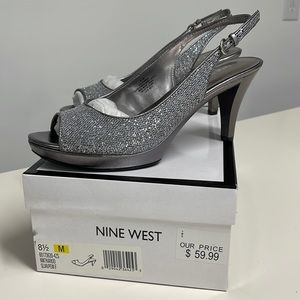 Nine West, size 8.5, silver/ pewter, buckle back strap, open toe pump